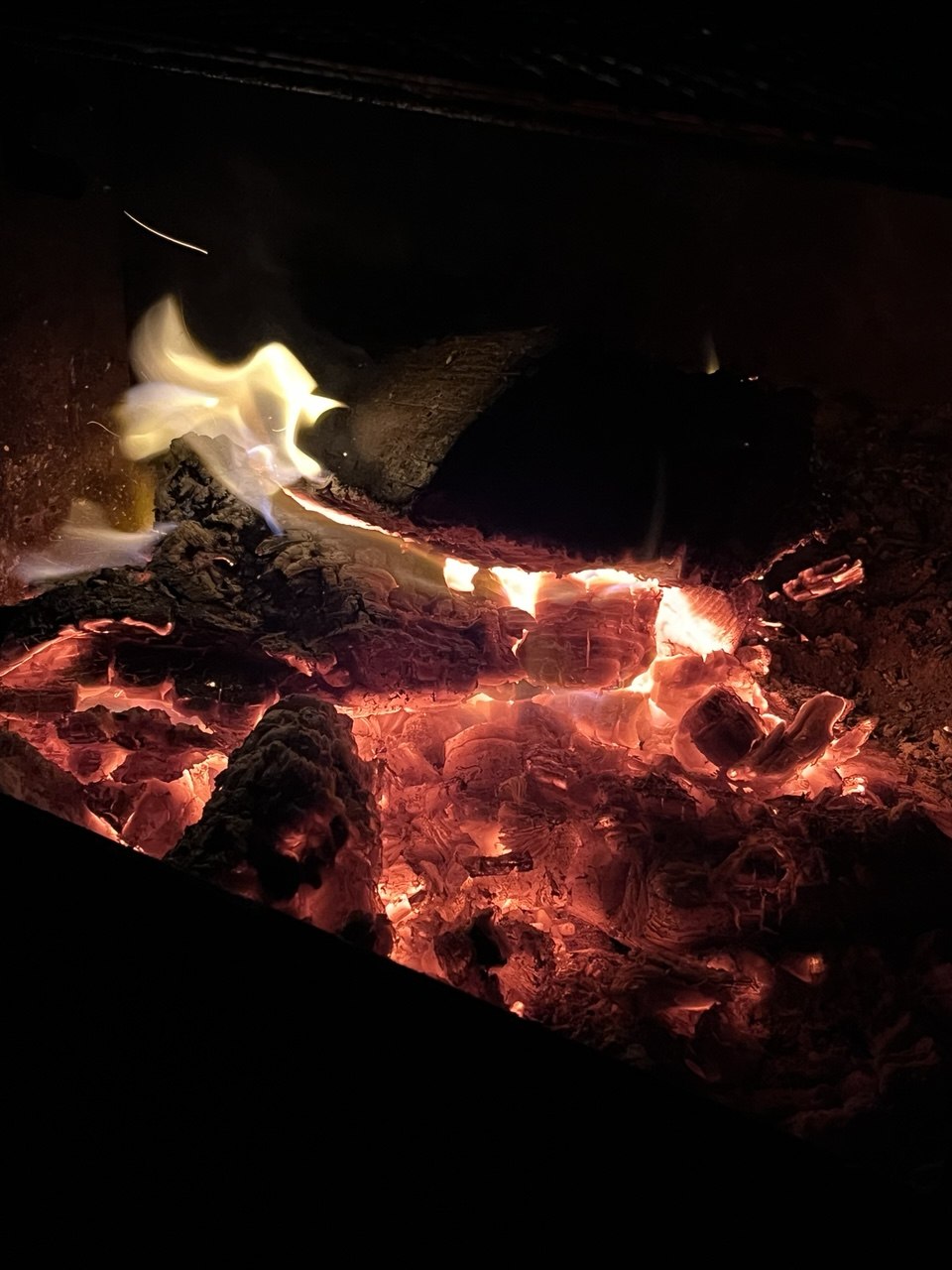 A glowing campfire during a KAWAN summer camping trip